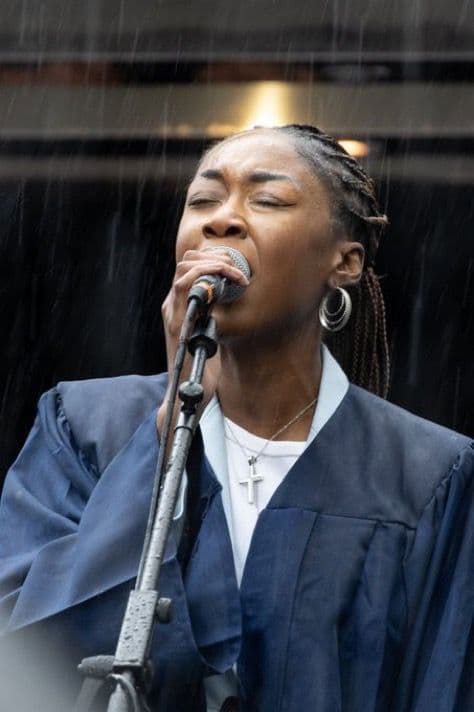 UTK Collective singer performing passionately in the rain